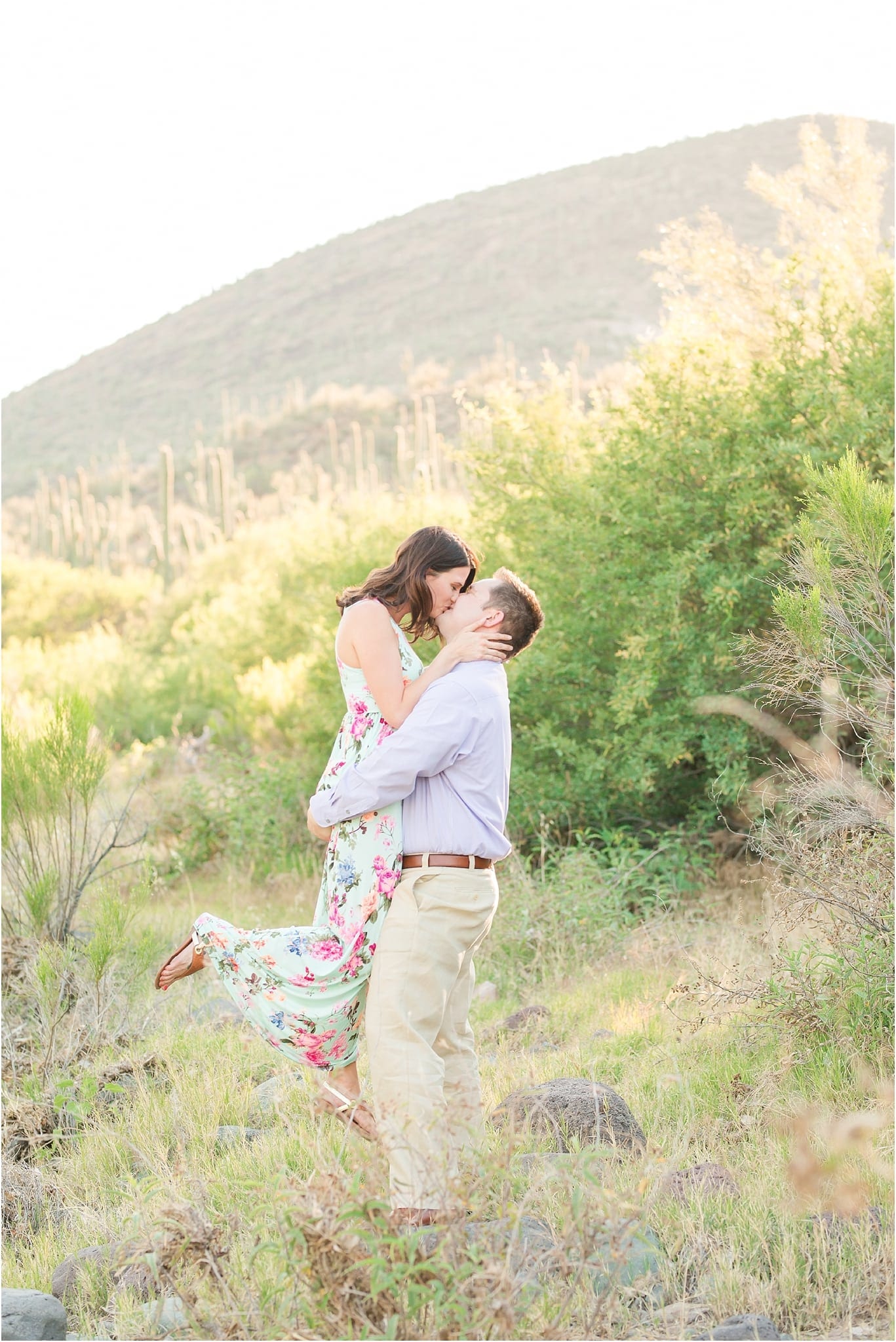 couple kissing in romantic desert engagement