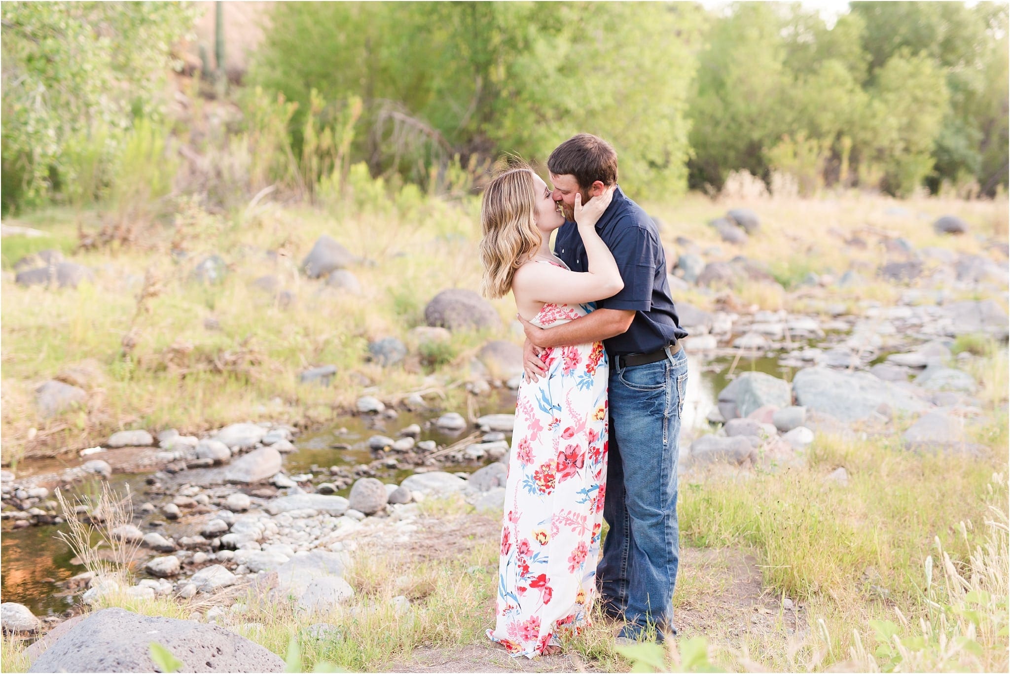 cave creek engagement photos - couple kissing by river