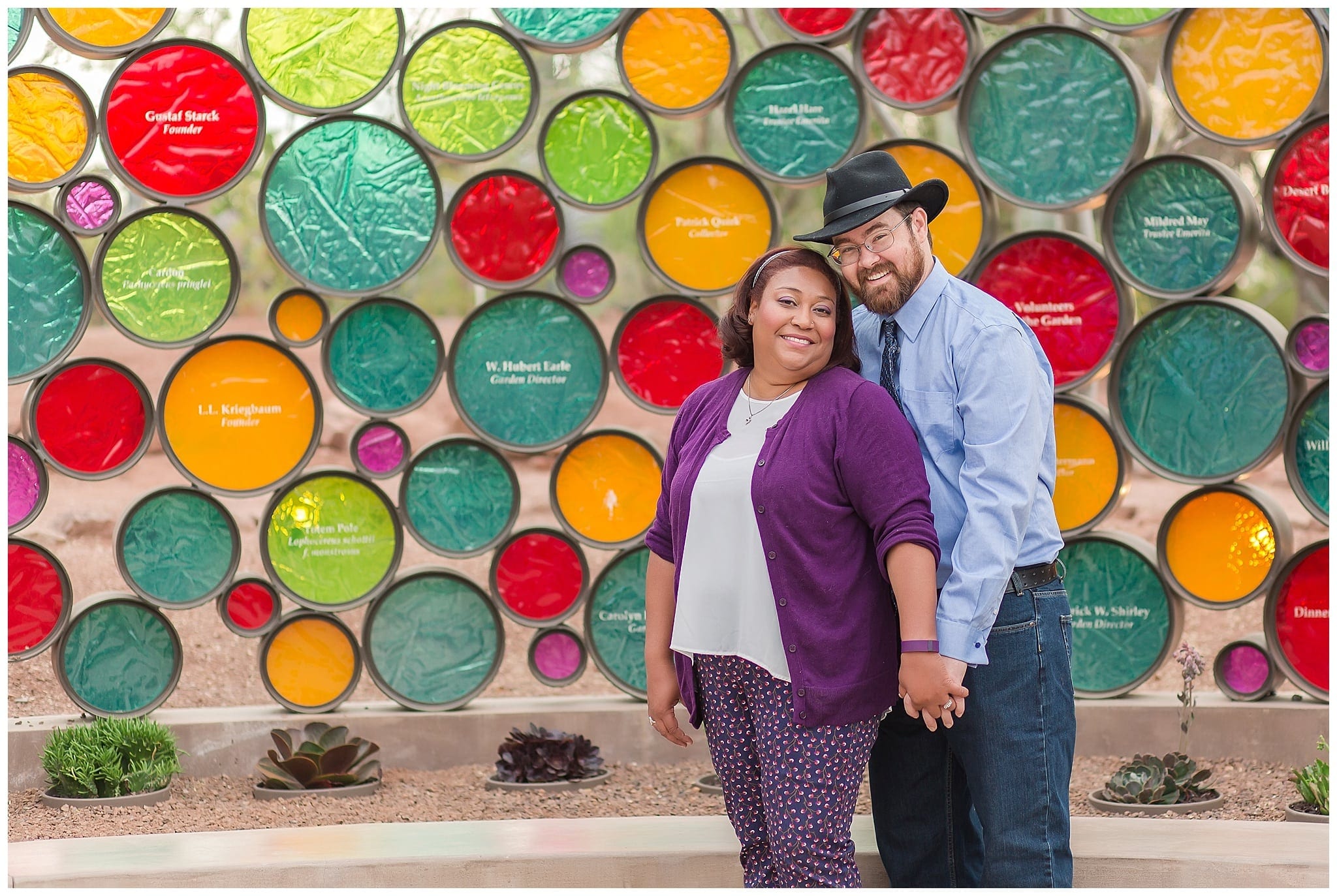 couple standing with random color circles behind them