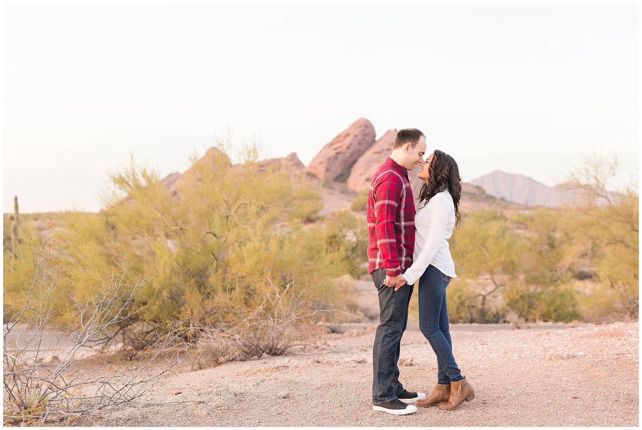 Couple kissing at Papago Park, Red rocks, white shirt, blue jeans, red plaid shirt, dancing