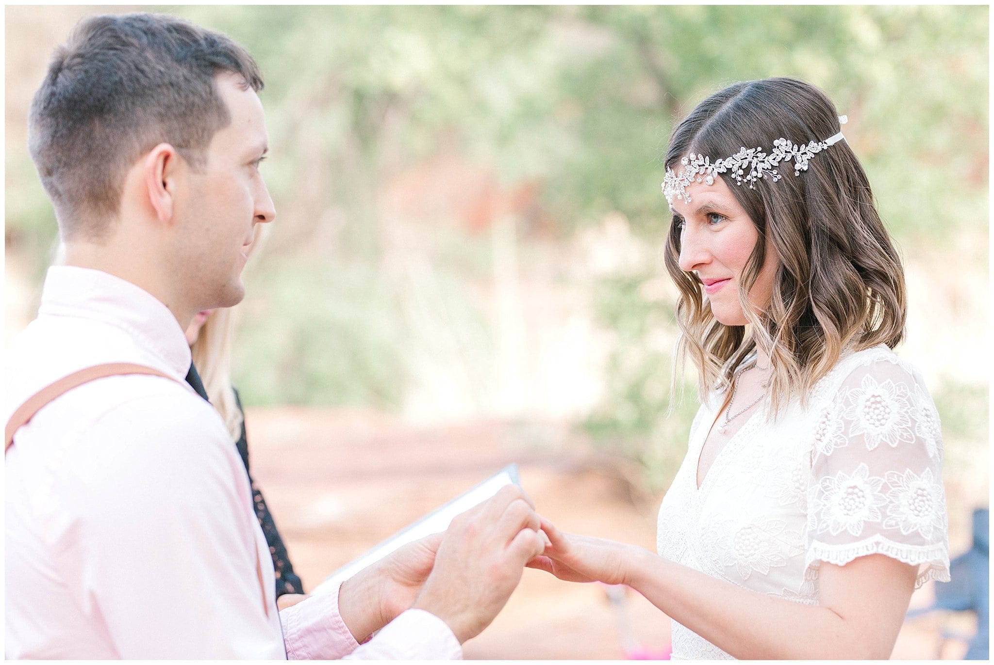 groom placing wedding ring on brides hand