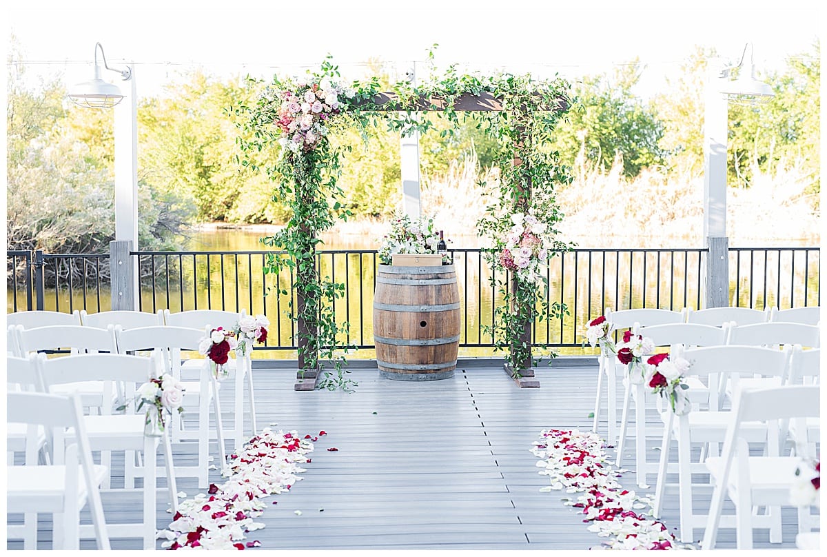 floral lined ceremony on dock at lake house