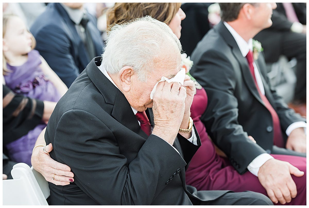 grandpa wiping eyes during ceremony