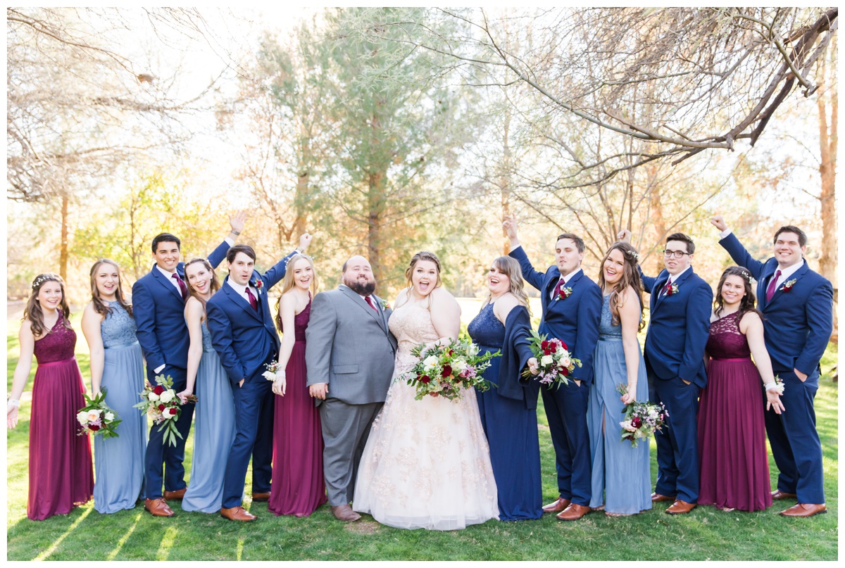 Light blue, navy, blush gowns, with bouquets of pink, white and red flowers