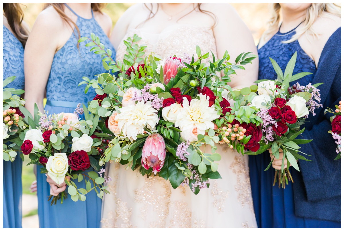 Light blue, navy, blush gowns, with bouquets of pink, white and red flowers