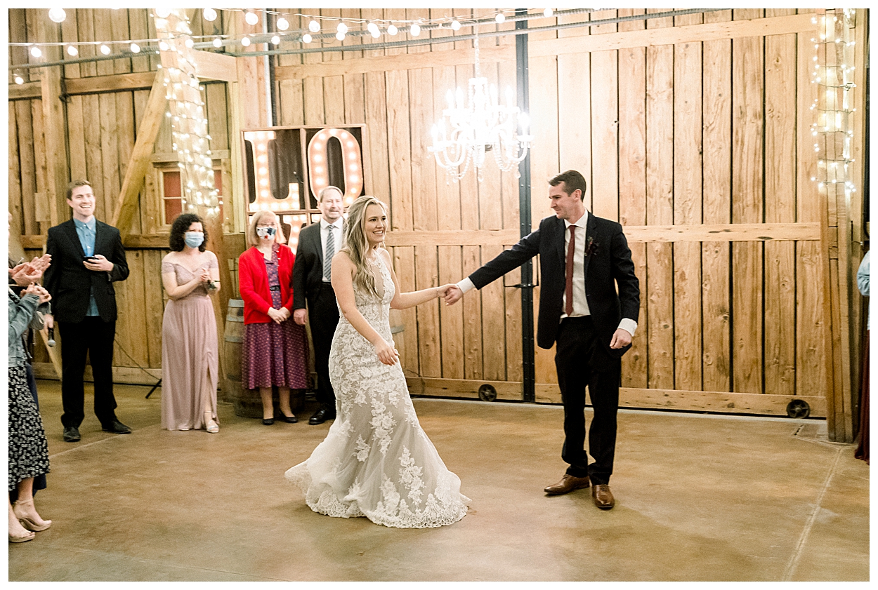 Inside windmill winery barn, bride and groom first dance