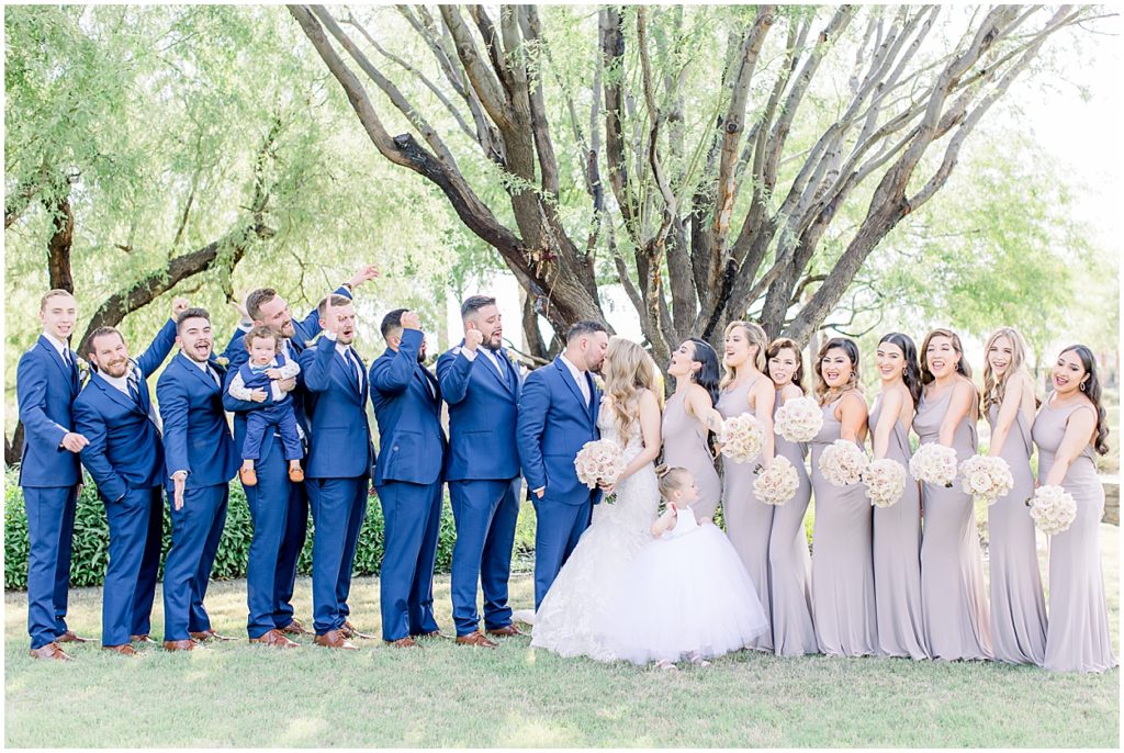 Bridal Party, Groomsmen in Blue Tuxedos, Leather Shoes, Bridesmaids in Mushroom Colored dresses, rose bouquest