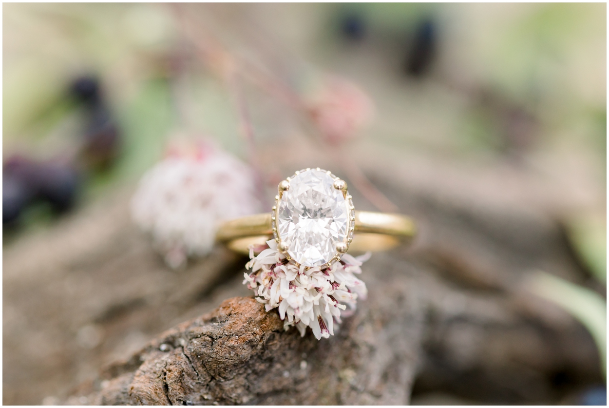 Engagement Ring on piece of wood with flower