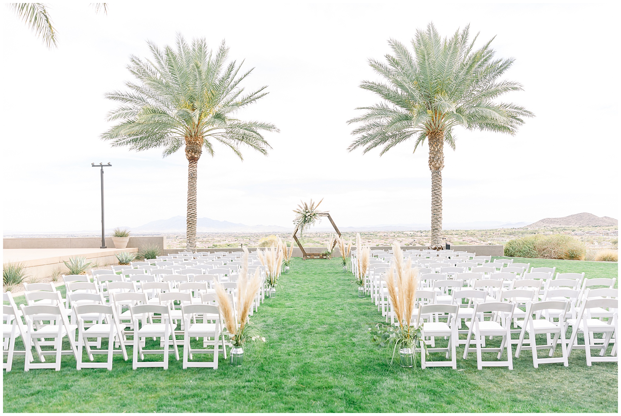 Ceremony Location at The Vic, Palm Trees, Pompous Grass, White Roses, Eucalyptus