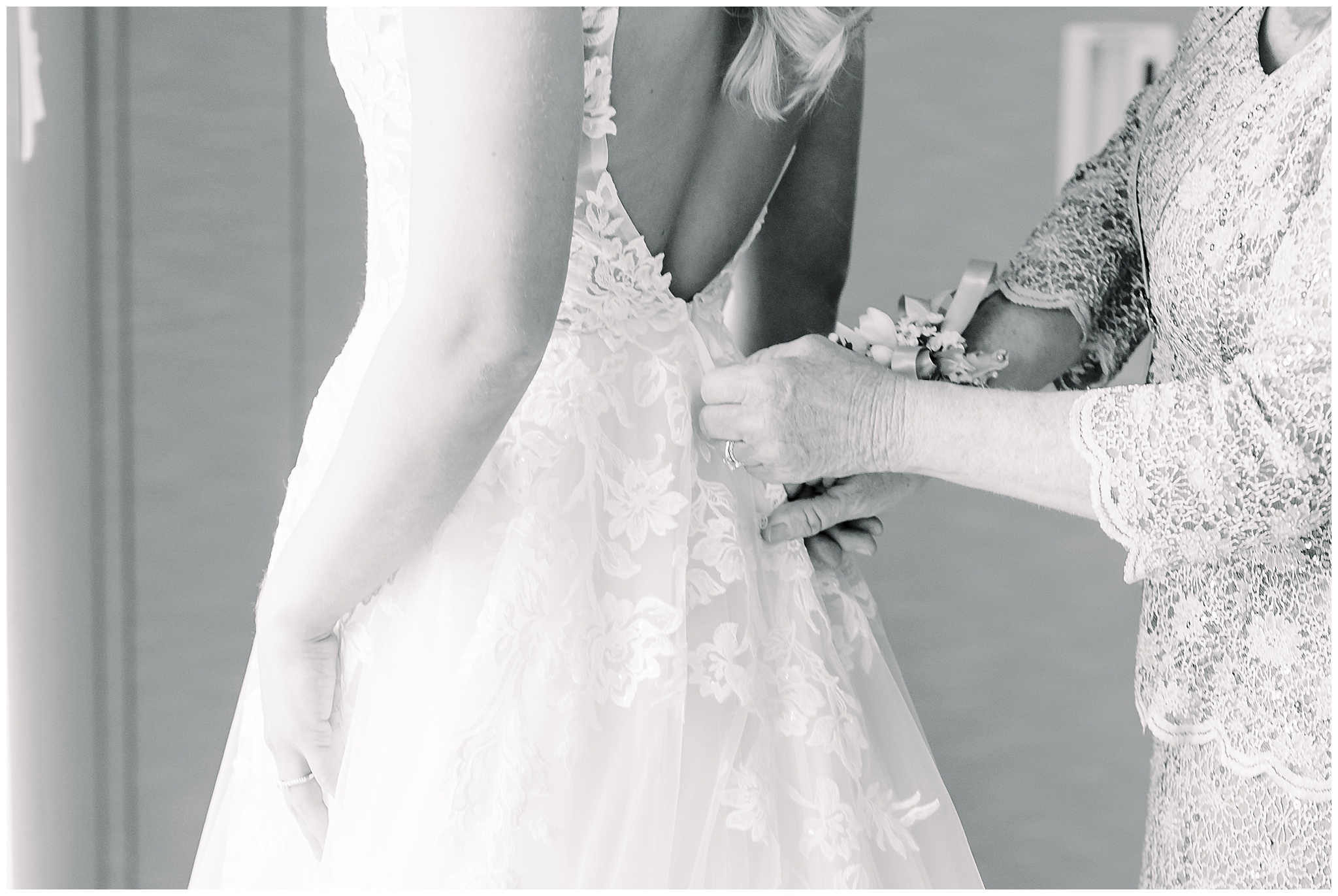 Hands zipping wedding dress