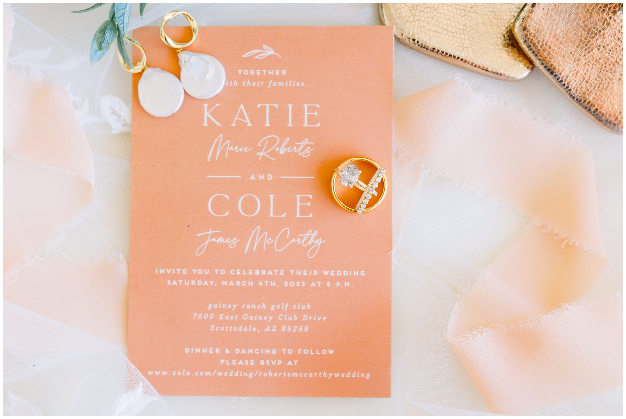 terracotta wedding invitation with three gold rings, pearl earrings