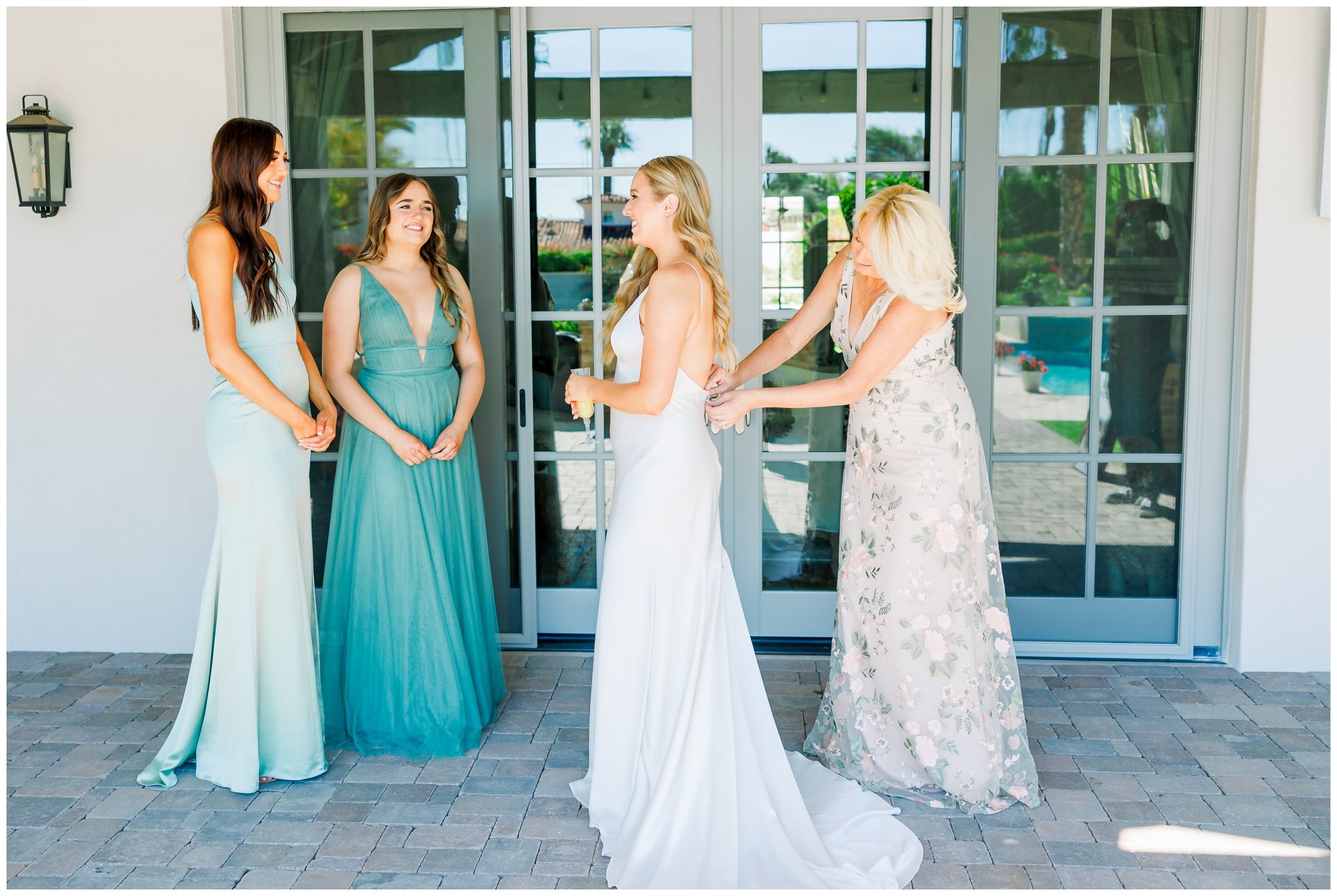 Bridesmaids helping mother of the bride get ready