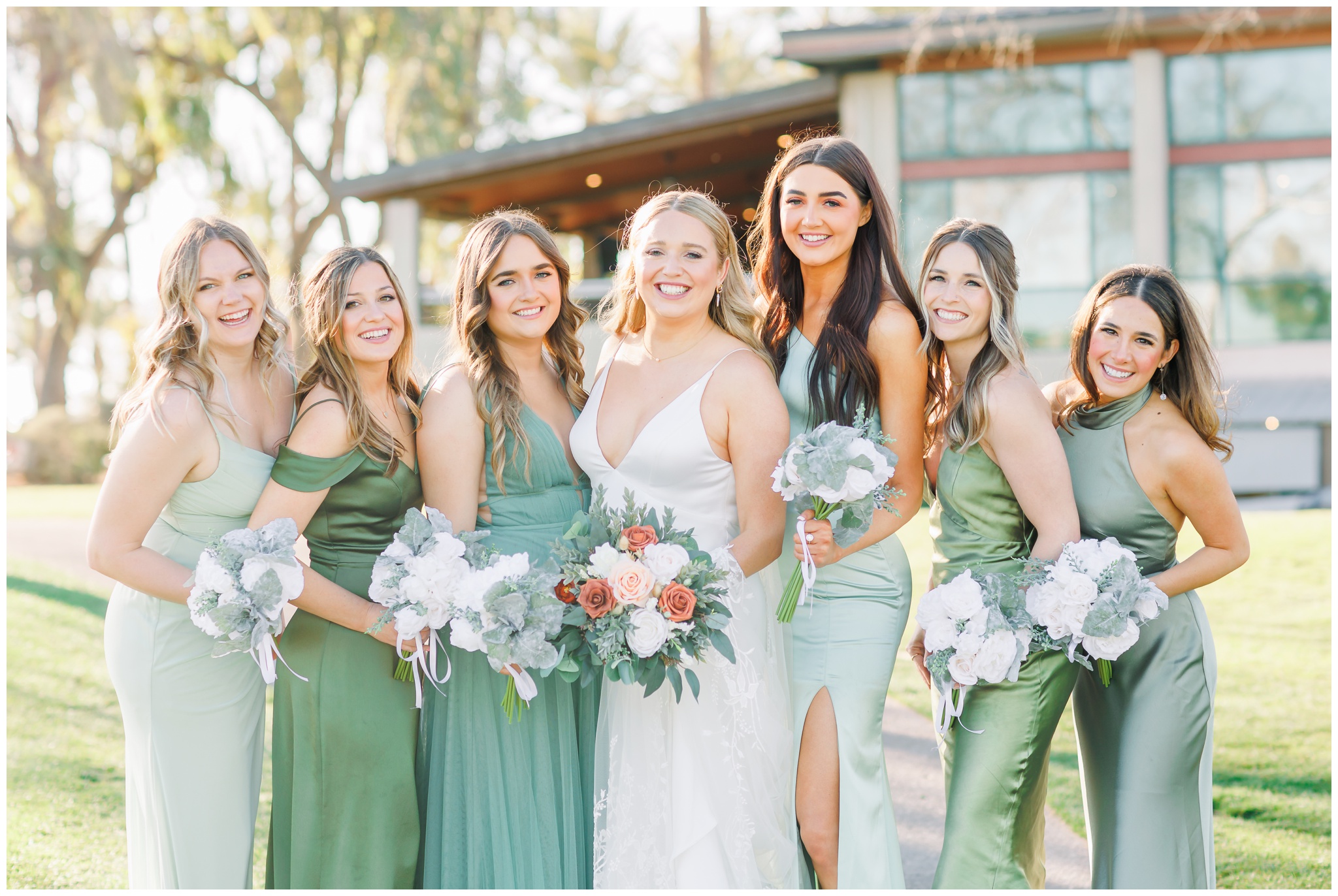 Bridesmaids in different shades of green dresses