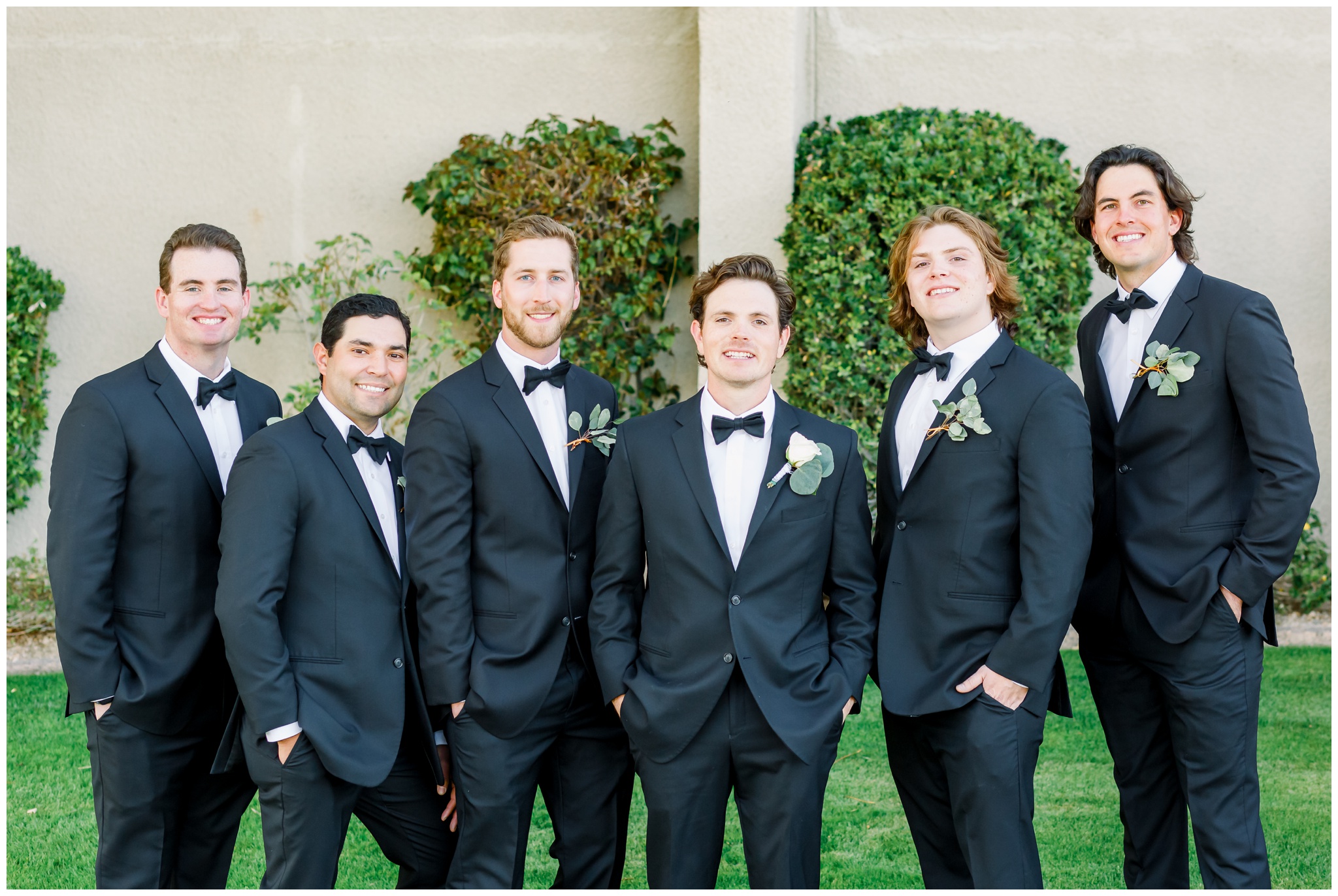 Groom with groomsmen walking at Gainey ranch in black tuxedos