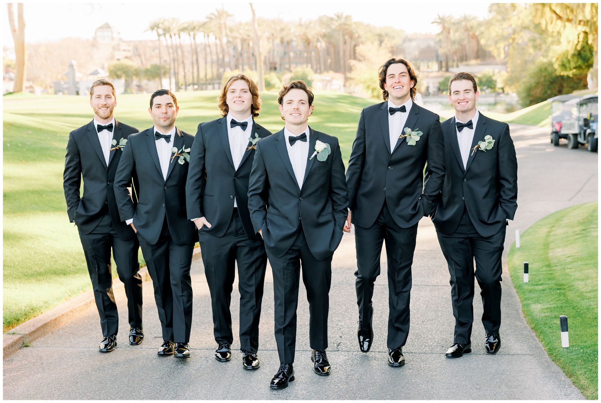 Groom with groomsmen walking at Gainey ranch in black tuxedos