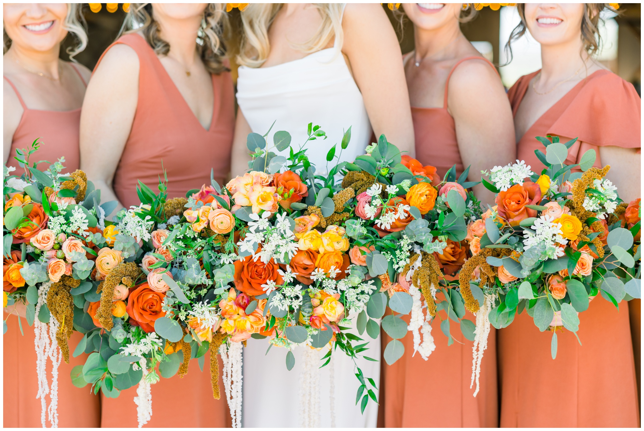 terracotta bridesmaid dresses with orange, yellow and red florals