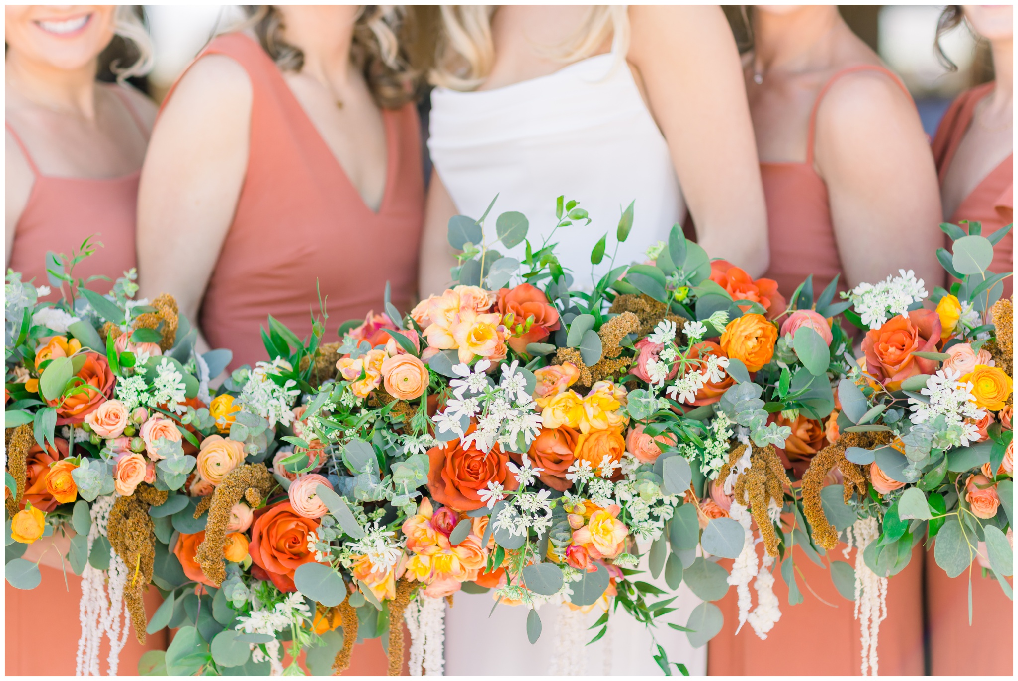 terracotta bridesmaid dresses with orange, yellow and red florals