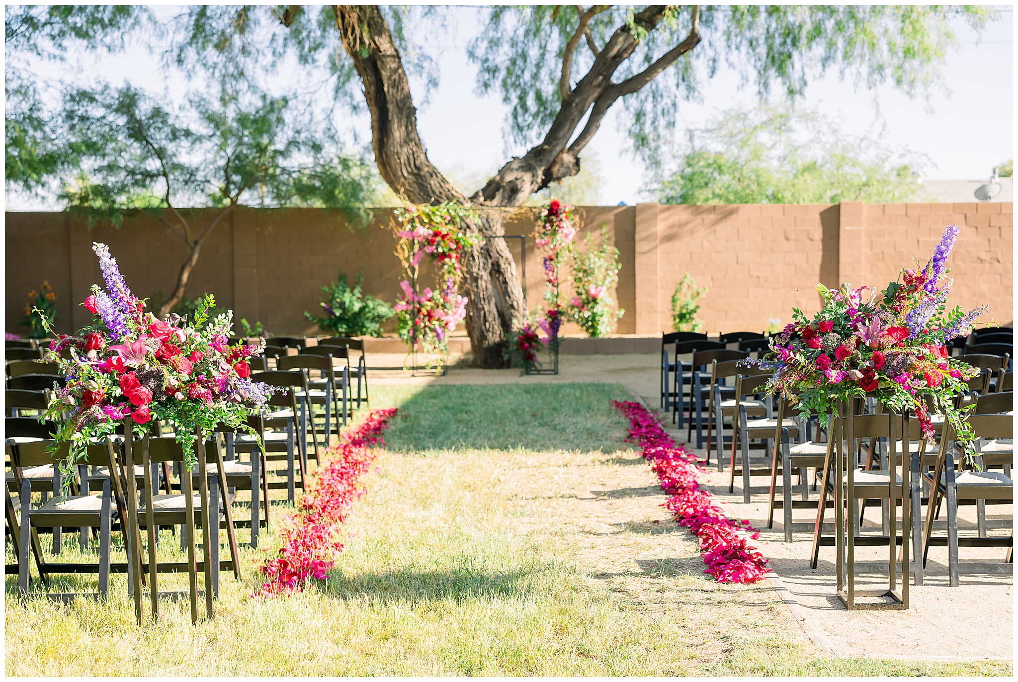 pink, purple, red florals with greenery, wedding ceremony