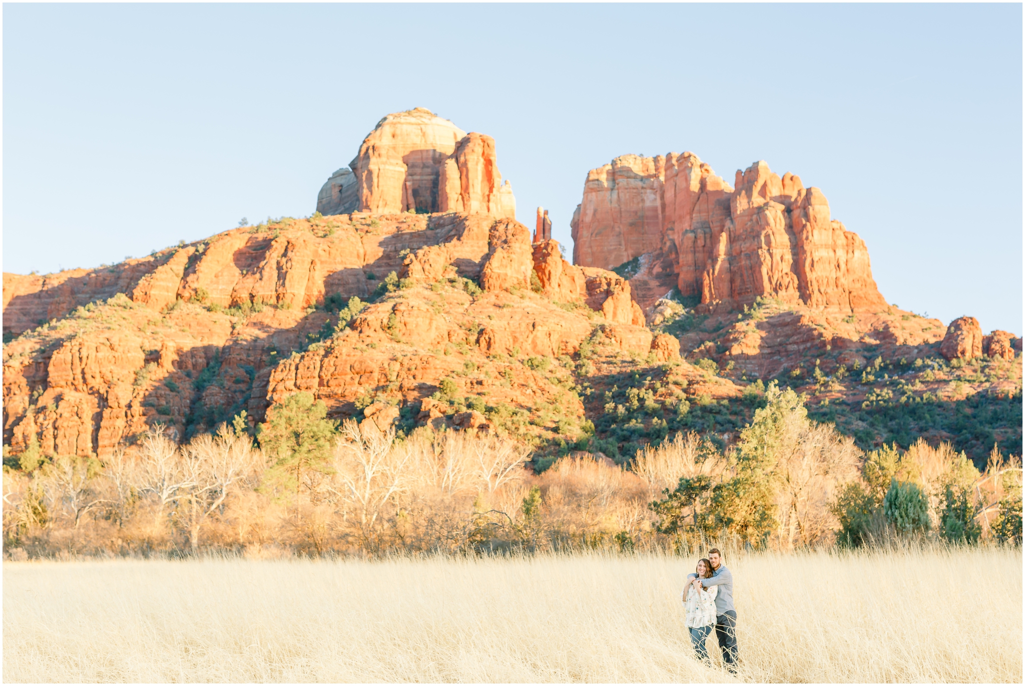 couple standing in front of Crescent Moon Ranch Red Rocks