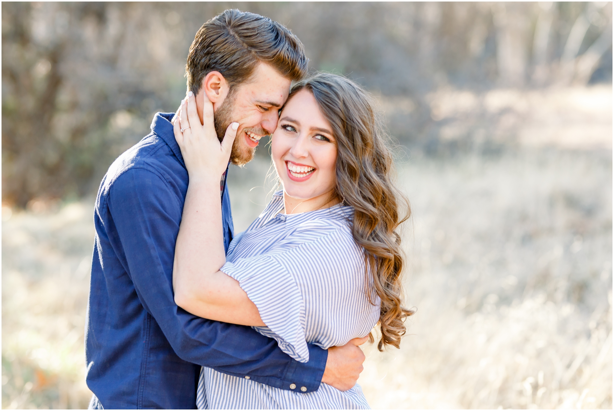 woman smiling holding fiancé's face